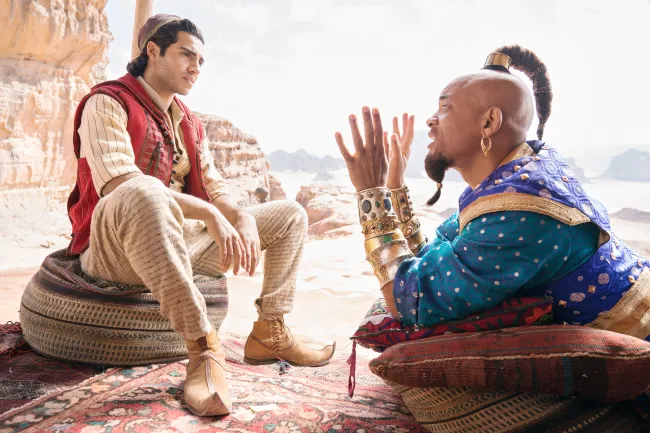 ALADDIN, from left: Mena Massoud as Aladdin, Will Smith as the Genie, 2019. ph: Daniel Smith / © Walt Disney Studios Motion Pictures / courtesy Everett Collection