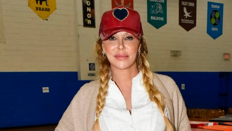 Brandi Glanville in a hat and pigtails