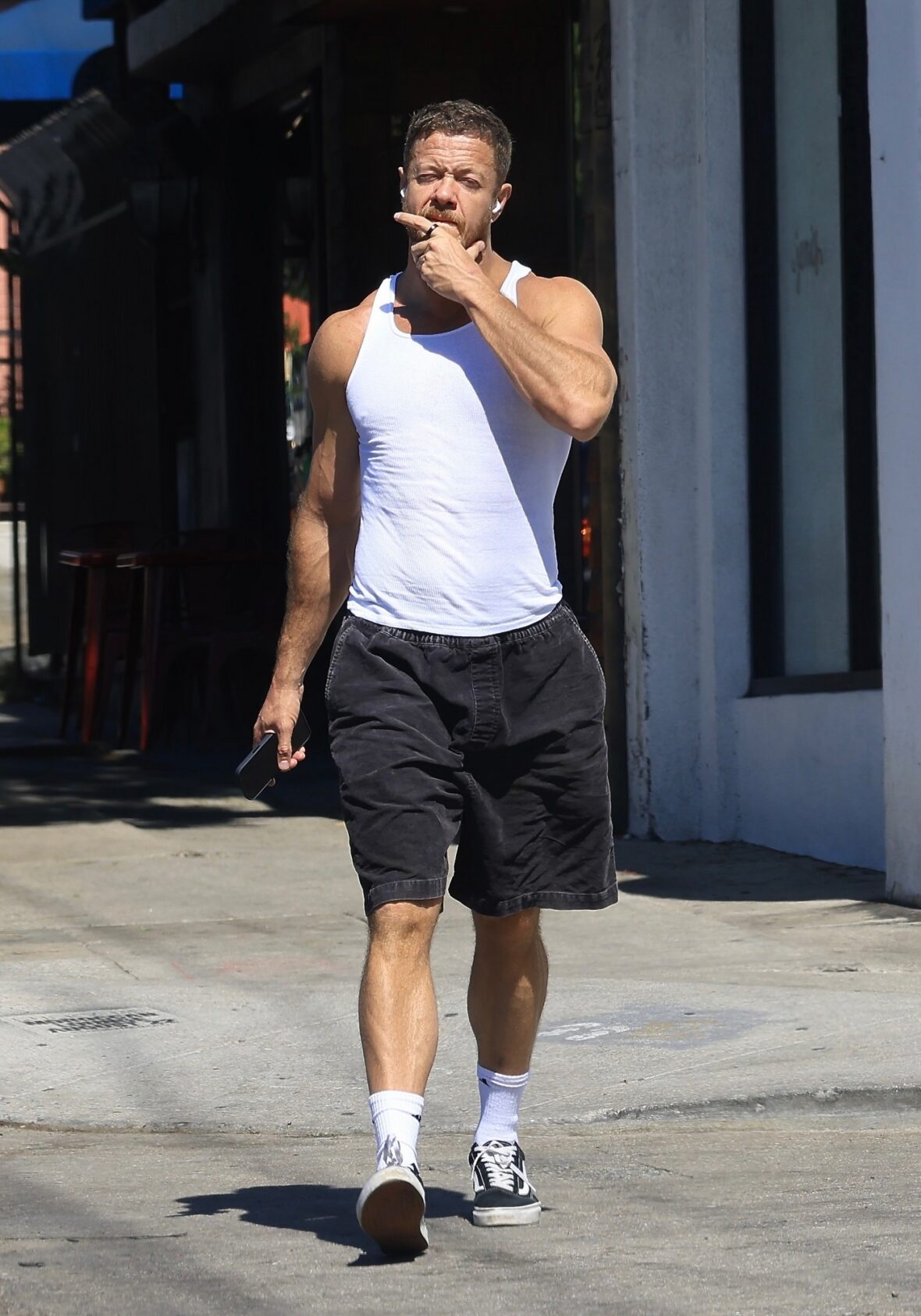 Dan Reynolds runs errands in a tank top