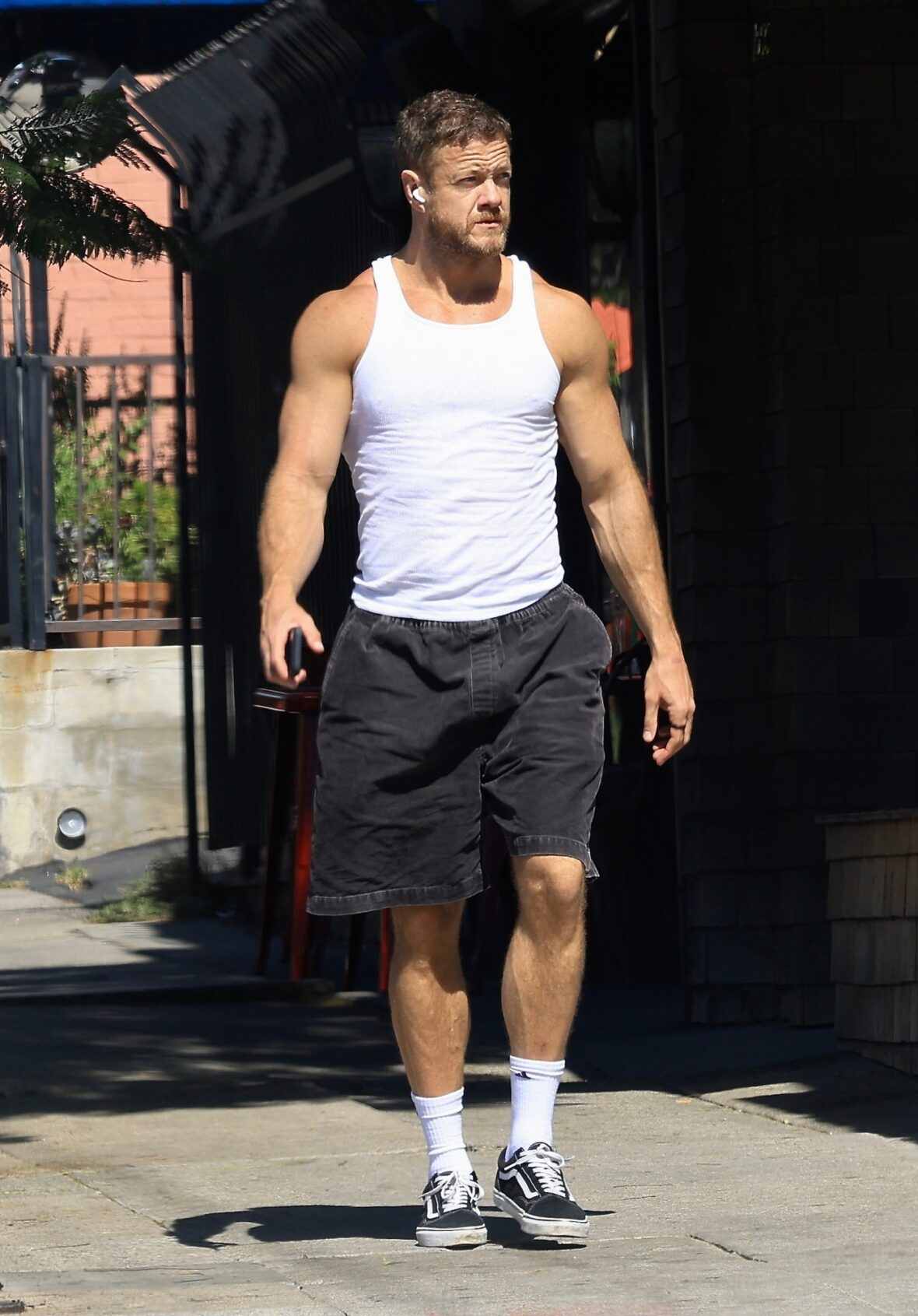 Dan Reynolds runs errands in a tank top
