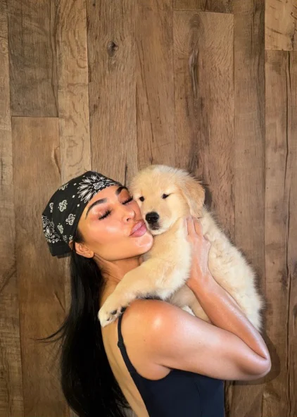 Kim Kardashian posing with her dog Halo