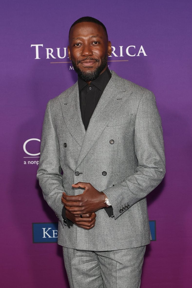 Lamorne Morris poses on the carpet at the Chrysalis Butterfly Ball