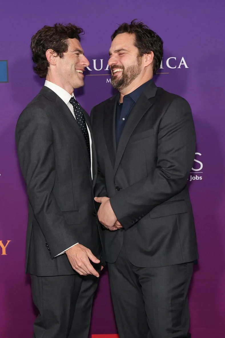Max Greenfield and Jake Johnson smile on the carpet at the Butterfly Chrysalis Ball