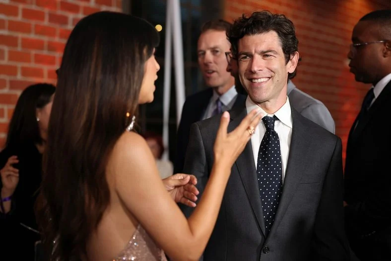 Hannah Simone and Max Greenfield chat on the carpet at the Chrysalis Butterfly Ball