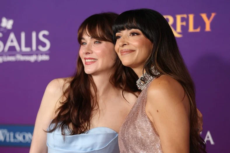 Zooey Deschanel and Hannah Simone pose on the carpet at the Chrysalis Butterfly Ball