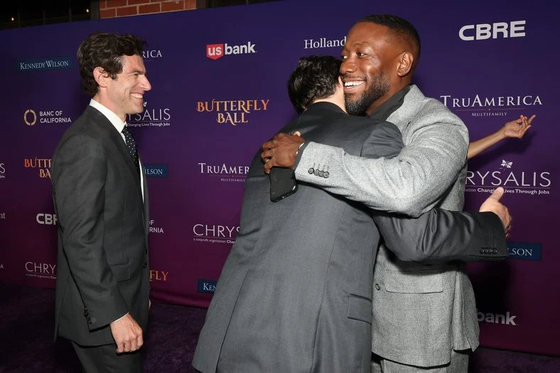 Jake Johnson and Lamorne Morris share a hug at the Chrysalis Butterfly Ball