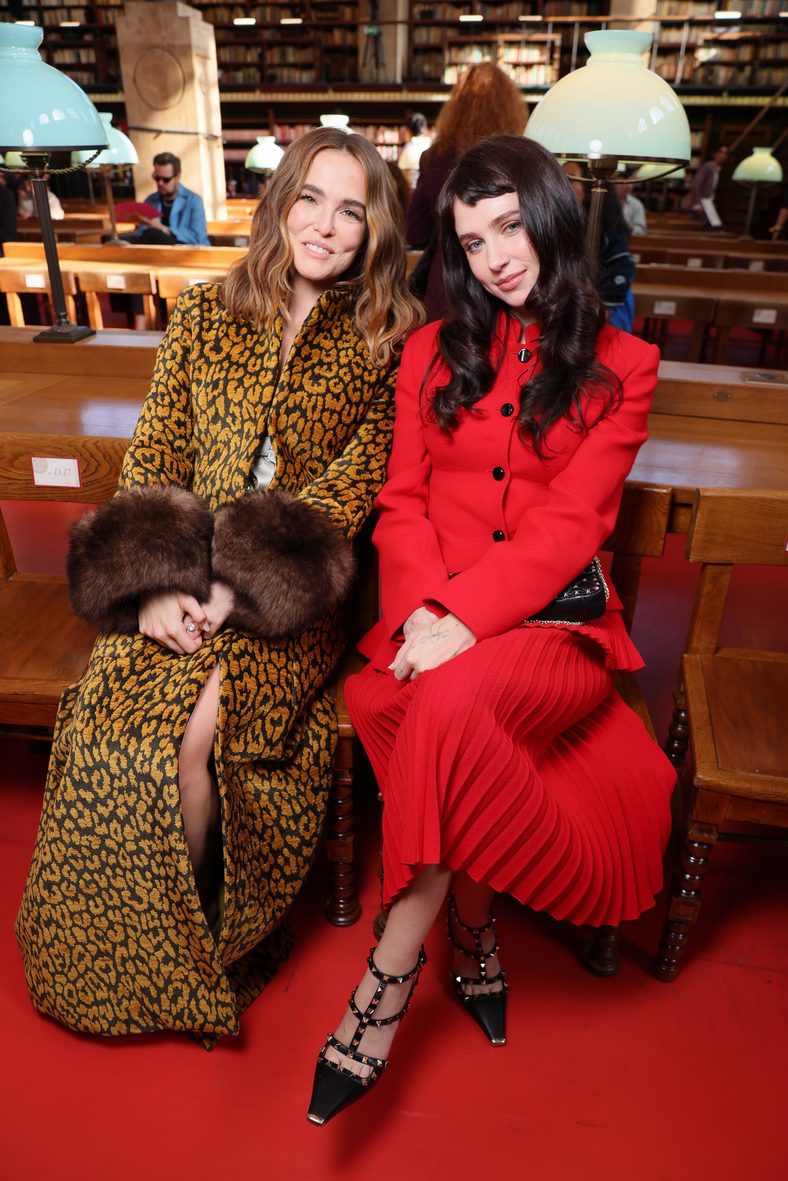 Zoey Deutch and Clairo pose for a photo at the Valentino fashion show